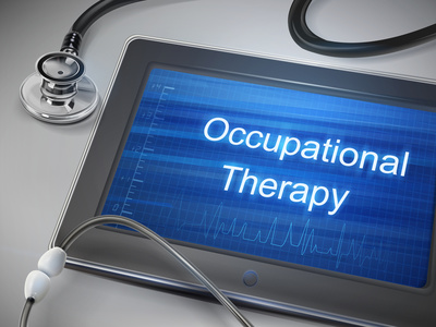 occupational therapy words displayed on tablet with stethoscope over table